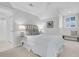 Cozy bedroom with neutral tones, a plush bed, and a window adorned with classic plantation shutters at 4983 Sound View Dr, Mount Pleasant, SC 29466