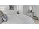 Bright bedroom featuring neutral tones, a bedside table, and a round mirror above a console table at 4983 Sound View Dr, Mount Pleasant, SC 29466