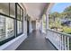 Spacious covered porch with white columns, and a ceiling fan, perfect for relaxing and entertaining at 4983 Sound View Dr, Mount Pleasant, SC 29466