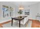 Bright dining room with a wooden table, white chairs, and a large window at 4983 Sound View Dr, Mount Pleasant, SC 29466