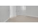 Empty room featuring neutral-toned carpet, clean white trim and doors, and large windows offering lots of light at 4983 Sound View Dr, Mount Pleasant, SC 29466