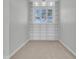 Empty room with neutral tones, a large window, plush carpet, and built-in shelving surrounding the window at 4983 Sound View Dr, Mount Pleasant, SC 29466