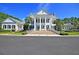 Grand two-story home featuring symmetrical design, white columns, and manicured landscaping at 4983 Sound View Dr, Mount Pleasant, SC 29466