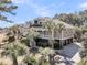Elegant home featuring a gray exterior, a porch, and lush landscaping with multiple palm trees at 4983 Sound View Dr, Mount Pleasant, SC 29466