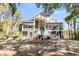 Beautiful home exterior featuring multiple porches, a large yard and mature landscaping at 4983 Sound View Dr, Mount Pleasant, SC 29466