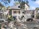 Well-maintained home with lush landscaping, screened porches, and multiple decks at 4983 Sound View Dr, Mount Pleasant, SC 29466