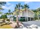 Stunning gray home with a three car garage, lush landscaping, and a welcoming stairway entrance at 4983 Sound View Dr, Mount Pleasant, SC 29466