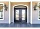 Elegant black double front doors flanked by stylish lanterns, adding curb appeal to this residence at 4983 Sound View Dr, Mount Pleasant, SC 29466