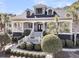 Charming two-story home with a welcoming front porch, manicured landscaping and mature palm trees at 4983 Sound View Dr, Mount Pleasant, SC 29466