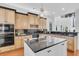 Large kitchen with an island, wooden cabinets, dark countertops, and stainless steel appliances at 4983 Sound View Dr, Mount Pleasant, SC 29466