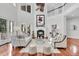 Bright living room features a fireplace, hardwood floors, comfortable seating, and natural light at 4983 Sound View Dr, Mount Pleasant, SC 29466