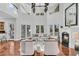 Bright living room with a fireplace, soaring ceilings, with multiple french doors, and beautiful floors at 4983 Sound View Dr, Mount Pleasant, SC 29466