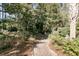 Charming brick path winding through a lush, green landscape with mature trees and shrubs at 4983 Sound View Dr, Mount Pleasant, SC 29466