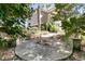 Beautiful brick patio outside a home featuring palm trees, a grey exterior, and well-maintained landscaping at 4983 Sound View Dr, Mount Pleasant, SC 29466