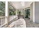 Inviting covered porch with a hot tub, tiled floor, and outdoor living space at 4983 Sound View Dr, Mount Pleasant, SC 29466