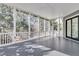Spacious screened in porch with gray floors, white railings and posts and lots of natural light at 4983 Sound View Dr, Mount Pleasant, SC 29466