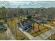 Aerial view of house showcases roof, driveway, and surrounding neighborhood with trees at 5037 Govan Rd, Hollywood, SC 29449