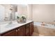 Bathroom featuring double sinks, a soaking tub, and ample counter space with neutral walls at 5037 Govan Rd, Hollywood, SC 29449