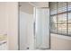 Bathroom featuring a stand up shower, a frosted glass door, and blinds on the window at 5037 Govan Rd, Hollywood, SC 29449