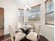 Bright breakfast nook features a glass-topped table, four chairs, and three windows with views at 5037 Govan Rd, Hollywood, SC 29449