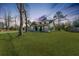 Charming home featuring a well-manicured lawn, inviting porch, and classic architectural details at 5037 Govan Rd, Hollywood, SC 29449