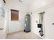 Functional laundry room with water heater, storage racks, and access to the exterior at 5037 Govan Rd, Hollywood, SC 29449