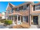 Charming brick townhouse with a covered front porch and dark shutters at 509 Reserve Way, Summerville, SC 29485