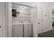 Efficient laundry room features washer, dryer, wire rack shelves, and folding doors at 509 Reserve Way, Summerville, SC 29485