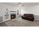 Living room with a stone fireplace, ceiling fan, glass door access to a patio or deck at 509 Reserve Way, Summerville, SC 29485