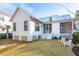 Spacious backyard with a well-maintained lawn, white siding, and a screened porch perfect for outdoor relaxation at 5742 Kiawah River Dr, Johns Island, SC 29455