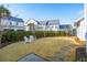 Well-manicured backyard featuring a lush lawn, stone pathway, and privacy fence at 5742 Kiawah River Dr, Johns Island, SC 29455