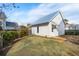 Charming backyard featuring a well-manicured lawn and a cozy cottage-style home with a metal roof at 5742 Kiawah River Dr, Johns Island, SC 29455