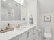 Clean bathroom featuring a marble countertop, a large mirror, and updated fixtures at 5742 Kiawah River Dr, Johns Island, SC 29455