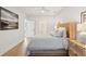 Light-filled bedroom featuring hardwood floors, woven accents, and ensuite bathroom at 5742 Kiawah River Dr, Johns Island, SC 29455