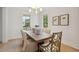 Elegant dining room with a wooden table, stylish chairs, and ample natural light from large windows at 5742 Kiawah River Dr, Johns Island, SC 29455