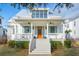 Charming two-story home featuring a welcoming front porch, stylish shutters, and a well-manicured lawn at 5742 Kiawah River Dr, Johns Island, SC 29455