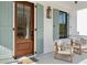 Inviting front porch with comfortable seating, wood door, and decorative shutters perfect for relaxation at 5742 Kiawah River Dr, Johns Island, SC 29455