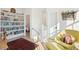 Hallway with custom bookshelf, chair, and natural light streaming through the nearby windows at 5742 Kiawah River Dr, Johns Island, SC 29455
