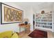 Inviting hallway with built-in bookshelves, vintage desk, and cozy seating area for reading or relaxing at 5742 Kiawah River Dr, Johns Island, SC 29455