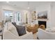 Cozy living room featuring a fireplace, built-in shelves, comfortable seating, and access to a screened porch at 5742 Kiawah River Dr, Johns Island, SC 29455