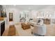 Spacious living room with hardwood floors, comfortable seating, and an open layout connecting to the kitchen at 5742 Kiawah River Dr, Johns Island, SC 29455
