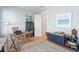 Sunlit office features hardwood floors, light blue walls, and eclectic decor at 5742 Kiawah River Dr, Johns Island, SC 29455