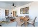 Comfortable screened porch featuring dining area, ample seating, and a ceiling fan at 5742 Kiawah River Dr, Johns Island, SC 29455