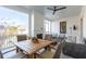 Comfortable screened porch features dining area, ample seating, and outdoor fireplace at 5742 Kiawah River Dr, Johns Island, SC 29455