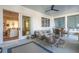 Relaxing screened porch features comfortable seating, dining area, and seamless indoor/outdoor flow at 5742 Kiawah River Dr, Johns Island, SC 29455