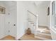 Bright staircase with wooden steps and white railing, complemented by light-colored walls and trim at 5742 Kiawah River Dr, Johns Island, SC 29455