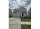 Charming two-story home with gray siding, a two-car garage, and a well-manicured front lawn at 598 Red Monarch Way, Moncks Corner, SC 29461