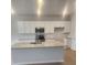 Modern kitchen with white cabinets, granite countertops, stainless steel appliances, and a center island at 598 Red Monarch Way, Moncks Corner, SC 29461