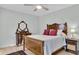 Bedroom with wood floors, ceiling fan, and a dresser with mirror at 6294 Highway 165, Ravenel, SC 29470