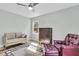 Bedroom with hardwood floors, ceiling fan, comfortable armchair, and antique furniture at 6294 Highway 165, Ravenel, SC 29470